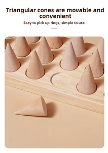Detail view of movable conical wooden ring stands on a solid rectangular tray