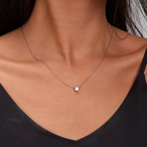 Elegant S925 sterling silver necklace featuring a single round zircon pendant on a model