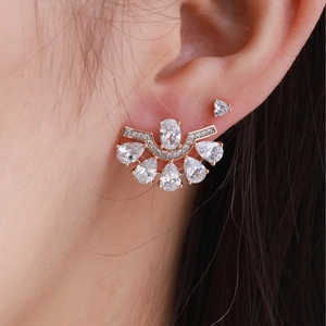 Elegant fan-shaped rose gold earrings with oval zircon and pear-cut stones on model