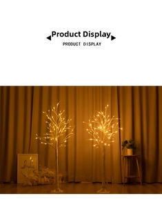 Detail view of two LED birch tree lights with warm yellow glow on square white bases