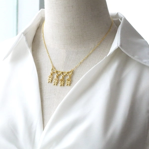 Gold heart family necklace with four figures pendants for women on white shirt