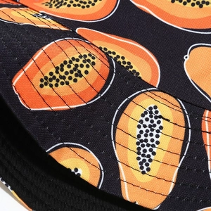 Close-up of durable canvas sun hat with orange papaya prints and neat double stitching