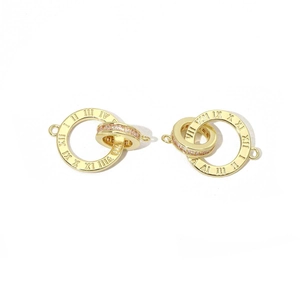 Detail of interlocking gold rings with Roman numeral engraving and cubic zirconia inlay