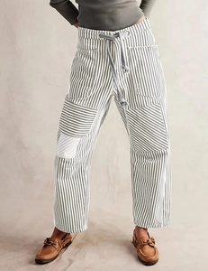 Detail of grey striped pants showing elastic drawstring waist and side pocket texture