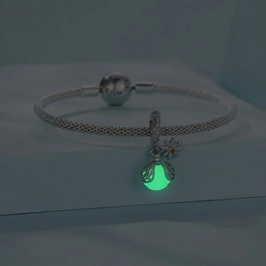 Luminous s925 silver firefly pendant on woven mesh bracelet with glowing green effect