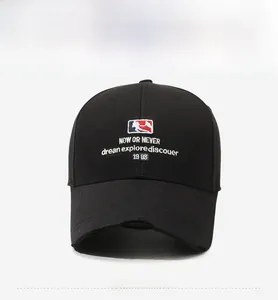 Detailed view of embroidery logo and distressed brim on a black baseball cap