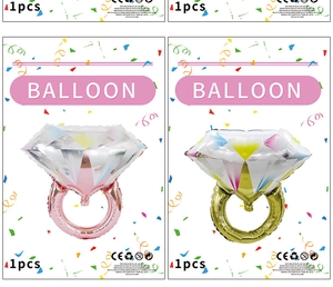 Detail of pink and gold diamond ring foil balloons in retail card packaging for party