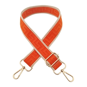 Close-up of orange adjustable wide shoulder strap with golden metal lobster clasps
