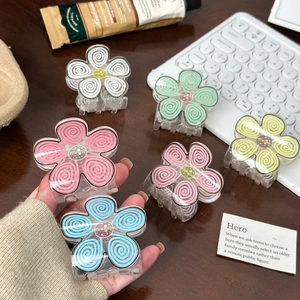 Set of colorful flower hair claws in macaron tones with textured petals and spiral patterns