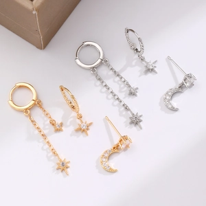 Three-piece gold and silver star moon earring set with cubic zirconia on white background