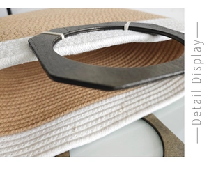 Detailed macro view of woven straw texture and premium dark brown wooden handle