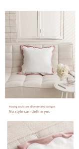 Detail of pink wavy ruffled edges and woven texture on a Nordic cat paw pillow cover