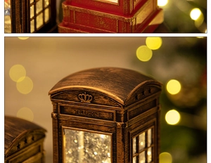 Macro shot of vintage red Christmas telephone booth lantern with glitter and warm LED glow