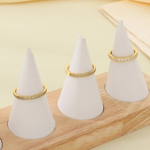 Three gold stainless steel eternity rings with white cubic zirconia on cone displays