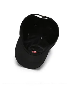 Detail of black baseball cap showing breathable mesh lining and adjustable metal buckle