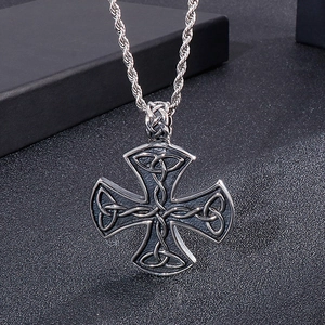 Macro view of vintage silver stainless steel Celtic knot cross pendant with twist chain