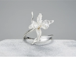 Macro shot of S925 sterling silver iris ring with matte petals on stone surface