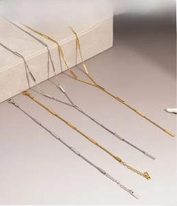 Detailed macro view of trendy gold and silver stainless steel chain necklace sets