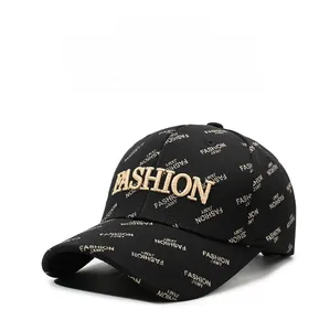 Detail of black baseball cap with all-over gold letter embroidery and twill texture