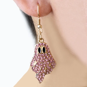 Detailed view of ghost earrings featuring pink rhinestones and black eyes on a model