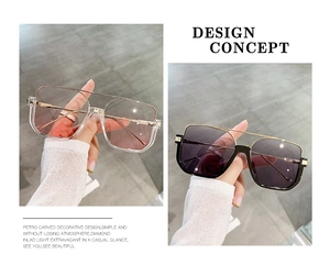 Detail of oversized double-bridge sunglasses with transparent pink and dark grey lenses