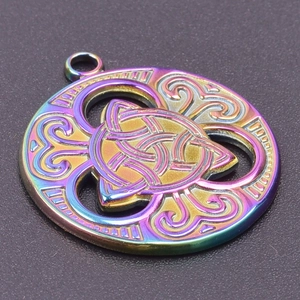 Macro shot of a rainbow-colored stainless steel circular Celtic Witch's Knot pendant