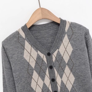 Women's grey V-neck argyle knit cardigan with black buttons on a wooden hanger