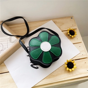 Detail of flower shaped kids crossbody bag in black and green with PU leather texture