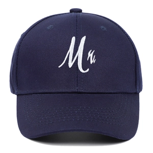 Detailed close-up of white Mr. embroidery on a navy blue cotton baseball cap