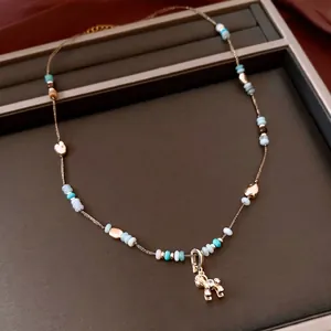 Beaded stone necklace with a golden puppy pendant and zircon stones in vintage style