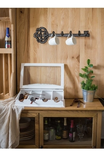 Detailed view of a rustic white wooden organizer box with four glass-lid compartments