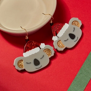 Pair of cute koala earrings wearing red glittery Santa hats for Christmas