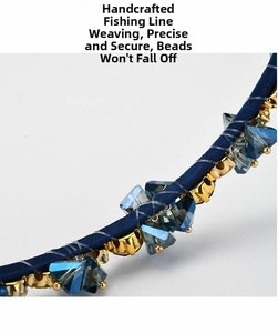 Close-up of handmade navy blue headband with luxury blue crystals and gold claw settings