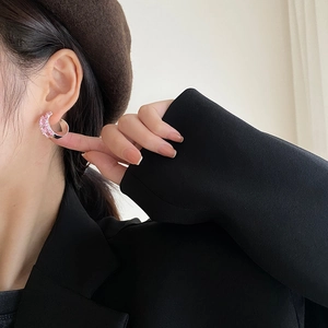 Elegant 925 silver C-shape earrings with pink zirconia worn by a stylish model