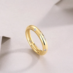 Detail of gold moissanite ring with small zircons shown from a 45-degree angle
