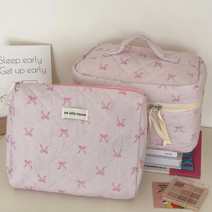 Pink quilted makeup bag set with ribbon bow embroidery and a convenient carry handle