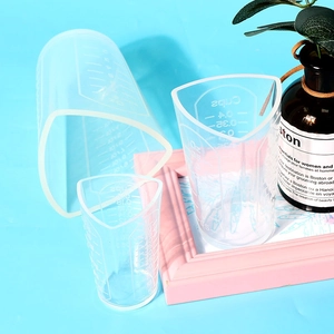 Detail of silicone measuring cups with spout design and dual scale for resin craft