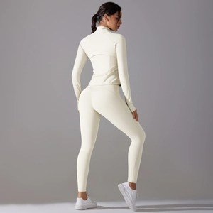Rear view of off-white yoga set showing high-waisted leggings and long sleeve sports jacket