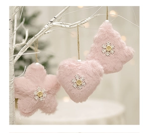Pink plush Christmas angel ornaments with stars and hearts hanging on white branches