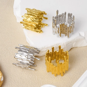 Detail of irregular molten lava textured open rings in gold and silver finish