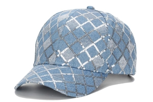 Detail of light blue denim baseball cap with silver sequin diamond grid pattern