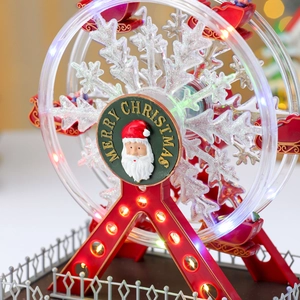 Close-up of a festive glowing Ferris wheel music box with Merry Christmas lettering