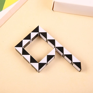 Macro shot of 24-segment black and white magic ruler puzzle toy in a folded square shape
