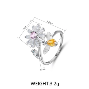 Rotating daisy and bee open ring featuring pink zircon and silver adjustable band