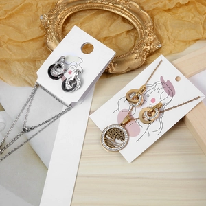 Detail of necklace and earrings sets on display cards with tree of life and pavé circle motifs