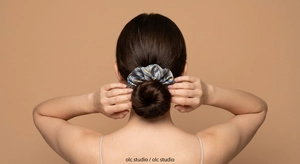 Starry blue oil painting satin scrunchie shown on a elegant hair bun for women
