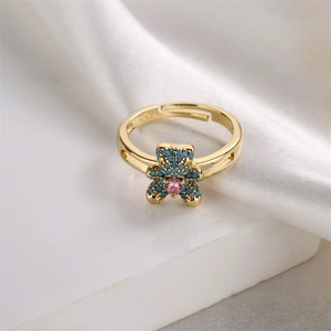 Close-up of adjustable bear ring with blue pave stones and pink heart zircon inlay