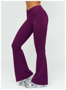 Detail of high-waist flared yoga pants featuring a stylish V-cross pleated waistband