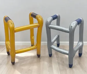 Detailed view of inflatable walker props in gold and silver PVC with 4-leg support