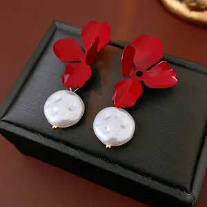 French vintage red flower earrings with white pearls on a black leather jewelry box